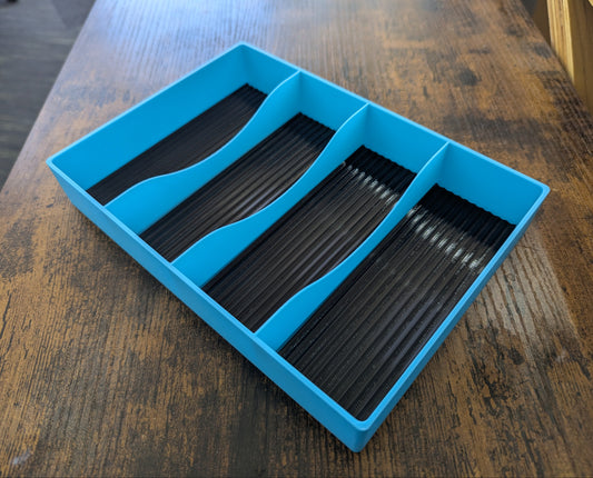 Blue tray with black compartments on a wooden surface