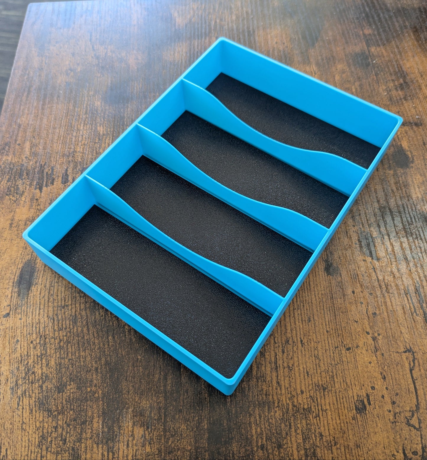 Blue silicone mold with four compartments on a wooden surface