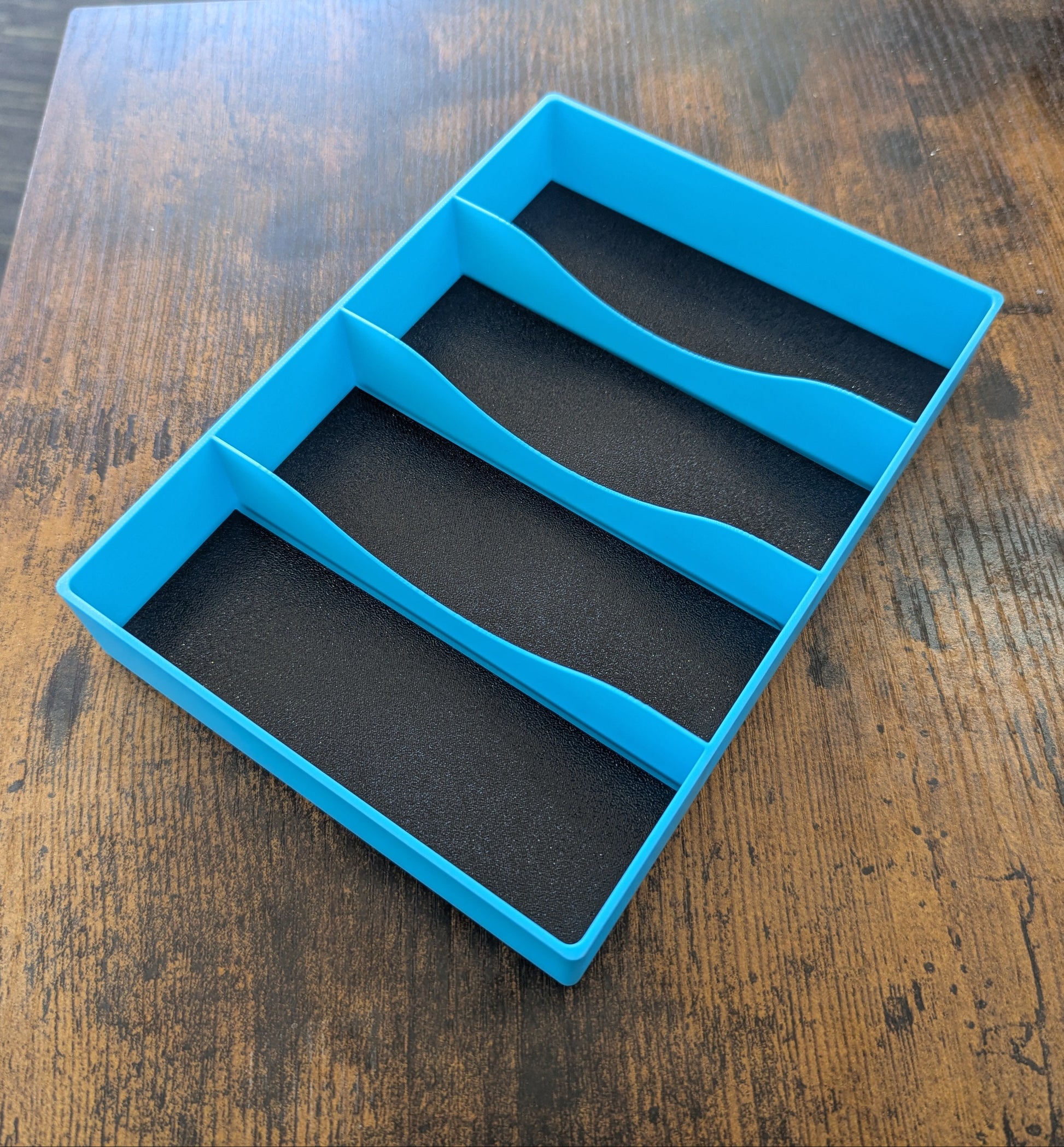 Blue silicone mold with four compartments on a wooden surface