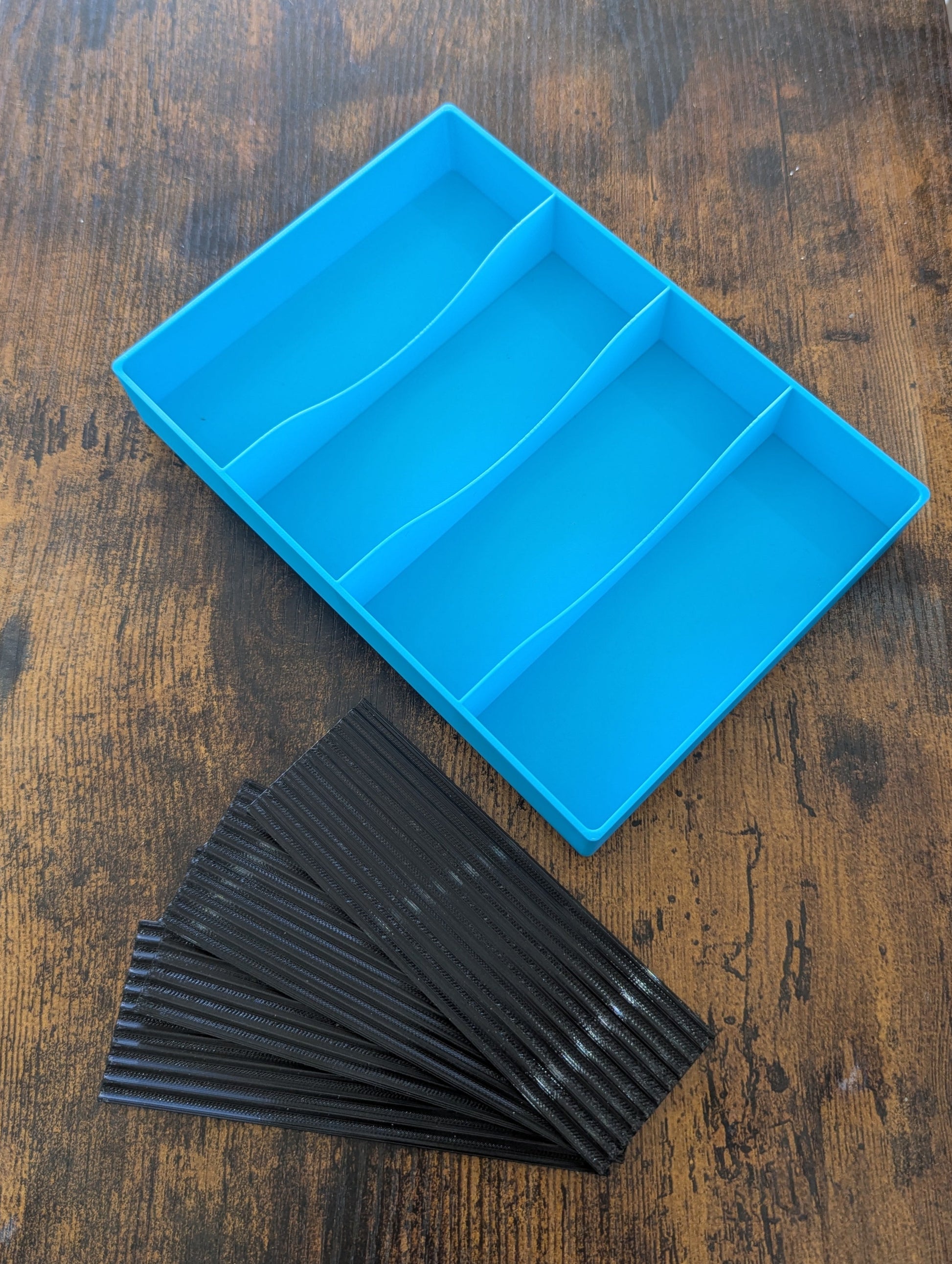 Blue tray with compartments on a wooden surface